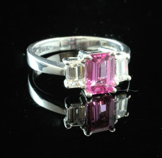 A platinum, pink sapphire and diamond three stone ring, size I.